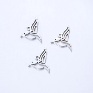 Macro detail of bird hummingbird pendants in polished hollow stainless steel metal