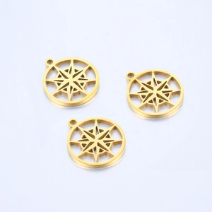 Close-up of three gold hollow compass star pendants for DIY jewelry making