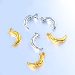 Detailed view of polished crescent moon charms in gold and silver for DIY jewelry