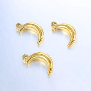 Detailed macro view of three gold crescent moon stainless steel pendants with top rings