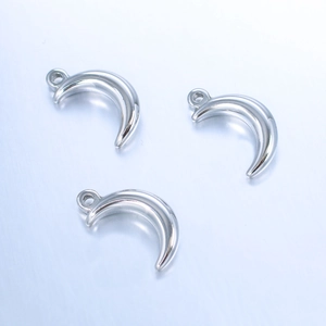 Macro shot of three polished stainless steel crescent moon pendants for DIY jewelry