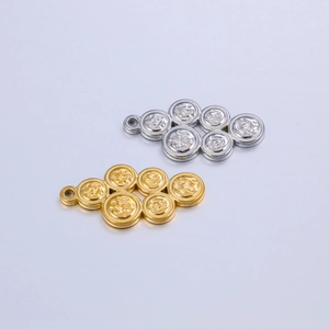 Detailed macro view of gold and silver geometric circular charms with embossed patterns