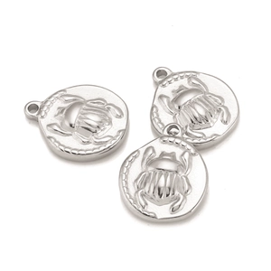 Detailed macro view of retro silver stainless steel scarab beetle coin pendants for jewelry