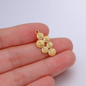 Detailed close-up of golden stainless steel geometric pendant with textured discs