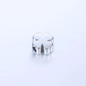 Close-up of polished stainless steel four-leaf clover charm with DIY stringing hole