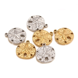 Macro view of gold and silver starfish shell pendants with embossed star textures
