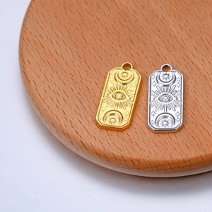 Rectangular celestial pendants in gold and silver with sun, moon and eye relief patterns
