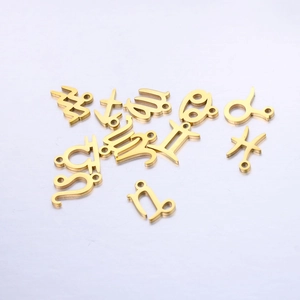 Macro shot of gold-plated zodiac symbol charms for DIY necklace and bracelet jewelry