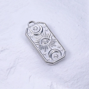 Detailed macro view of vintage silver rectangular celestial pendant with eye motif