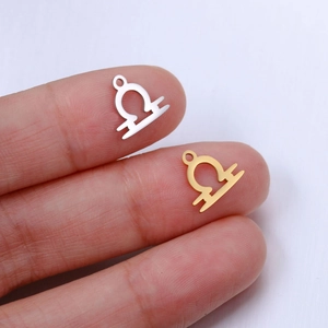 Close-up of Libra zodiac pendants in gold and silver finish for DIY jewelry