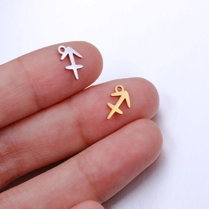 Macro view of Sagittarius zodiac pendants in polished gold and silver for DIY jewelry