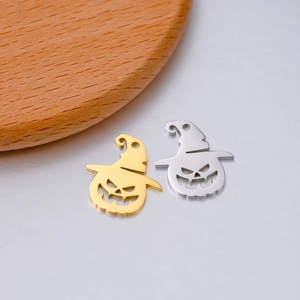 Detailed macro of gold and silver stainless steel pumpkin lantern pendants for DIY jewelry