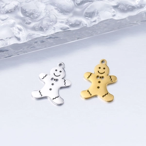 Macro view of gold and silver gingerbread man charms with polished metal finish and details