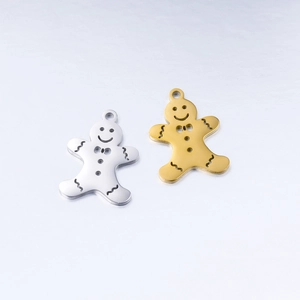 Macro detail of gingerbread man pendants in gold and silver polished stainless steel
