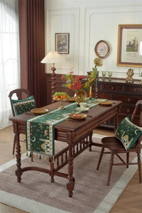 Detail of dark green table runner with golden tassels and Islamic mosque motifs