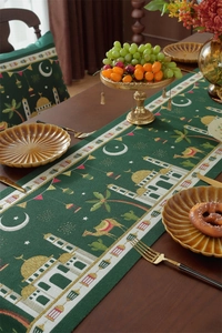Close-up of Eid Mubarak table runner with golden mosque and camel jacquard patterns