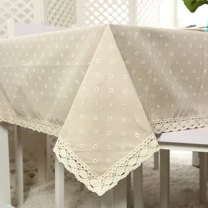 Close-up of white daisy print on cotton linen tablecloth with elegant lace edge trim