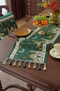 Detail of dark green Ramadan table runner with jacquard mosque patterns and colorful tassels
