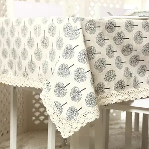 Detail of apple tree pattern on beige cotton linen tablecloth with lace edges