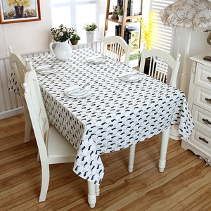 Modern rectangle cotton linen tablecloth featuring a blue whale pattern in a cozy home setting