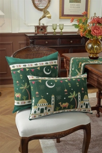 Detail of dark green Islamic themed cushion covers with mosque and camel embroidery patterns