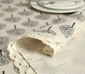 Close-up of apple tree print cotton linen tablecloth with elegant lace trim edge