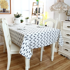 Close-up of modern ocean whale pattern on linen tablecloth with elegant drape and texture