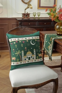 Detail view of dark green Ramadan table runner with tassels and matching crescent star pillow