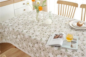 Detail of floral printed cotton table cloth with elegant white dandelion lace trim edge