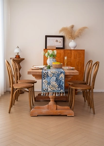 Close-up of blue tropical leaf jacquard table runner with decorative tassel fringe