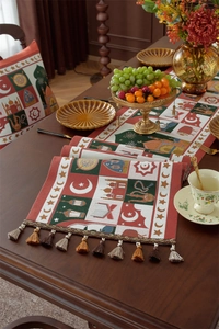 Detailed close-up of Ramadan jacquard table runner featuring lanterns and tassels