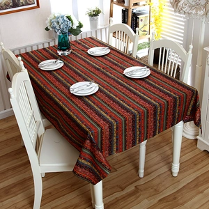 Detailed close-up of a bohemian cotton linen tablecloth with colorful gold-foil stripes