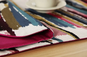 Macro shot of colorful oil painting stripe table runner with rose red satin lining
