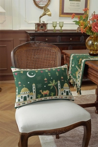 Close-up of rectangular emerald green lumbar pillow with gold moon and mosque patterns