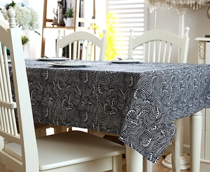 Detail of Japanese style wave pattern tablecloth with decorative lace edges on a table