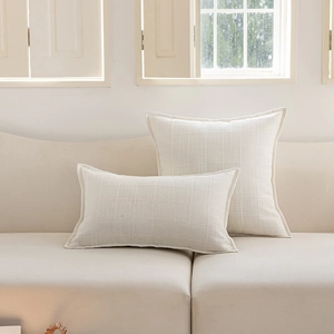 Detailed waffle texture and flange edges on cream minimalist polyester cushion covers