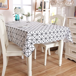 Detail of modern cotton tablecloth featuring black and white geometric triangle patterns