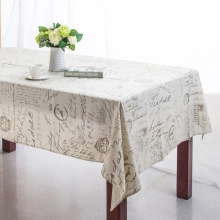 Detail of vintage postcard printed tablecloth with postage stamps and script on linen fabric