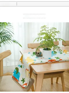 Detail of cartoon dinosaur print on cotton tablecloth with soft natural lighting setup