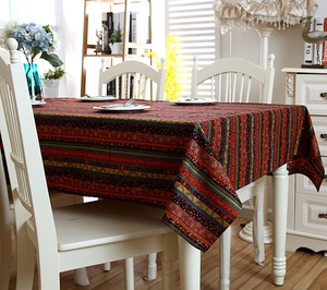 Bohemian striped linen tablecloth with tassel lace trim on a white dining table set