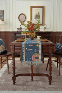 Close-up of Middle Eastern style table runner with mosque motifs and blue tassels