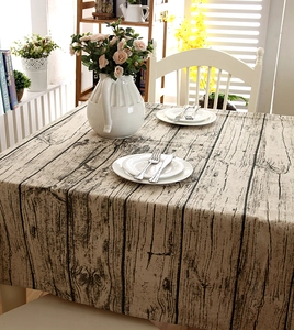 Detail of vintage faux wood grain tablecloth with rustic texture and natural drape