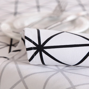 Detailed close-up of thick cotton canvas tablecloth with black geometric triangle patterns