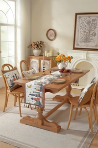 Close-up of woven polyester table runner with moon and castle patterns and tassels