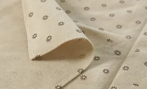 Detailed macro view of linen-cotton fabric with printed dark brown floral pattern