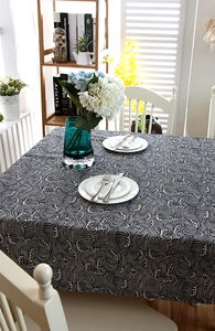 Close-up of black and white wave pattern tablecloth with decorative lace edges