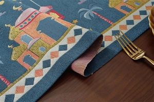 Macro detail of Middle Eastern jacquard table runner with golden embroidery and tassels