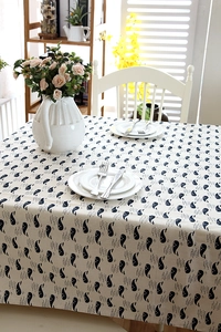 Macro detail of cotton linen tablecloth featuring blue whale patterns and fabric texture