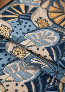 Macro shot of jacquard tropical leaf patterns on a premium blue table runner fabric