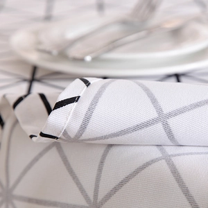 Close-up of modern geometric black and white cotton canvas tablecloth with hemmed edges